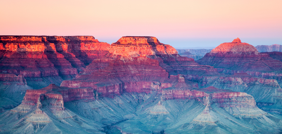 Bright red rock formations of the Grand Canyon at sunset